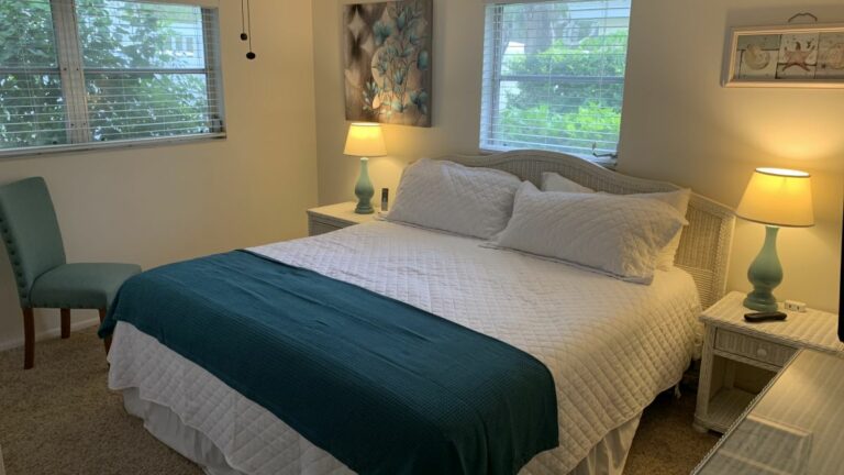 King size bedroom with closet space and en-suite bathroom. TV in room.